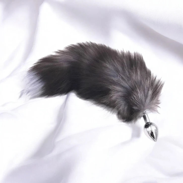 A metal anal plug with a fluffy faux fur tail, designed for playful pleasure.