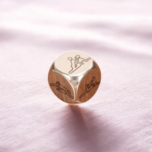 A metallic dice with sexual positions on 6 sides.