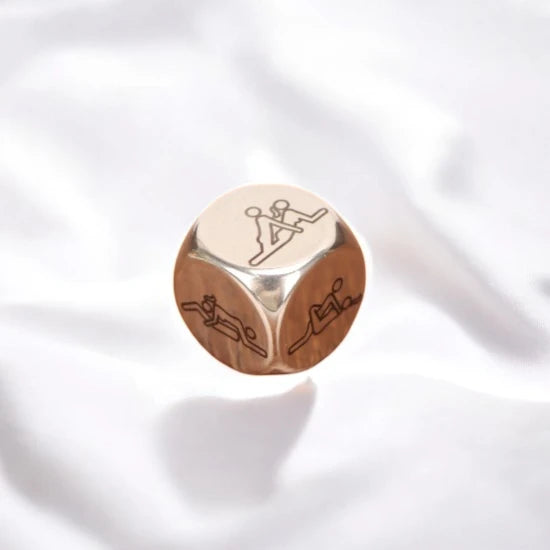 A metallic dice with different sexual positions on 6 sides.