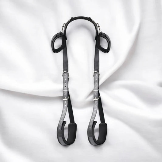 A pair of black bondage restraining straps with adjustable buckles and padding.