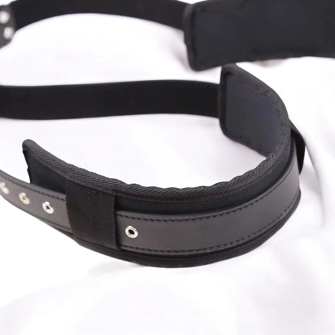 A pair of black bondage restraining straps with adjustable buckles and padding.