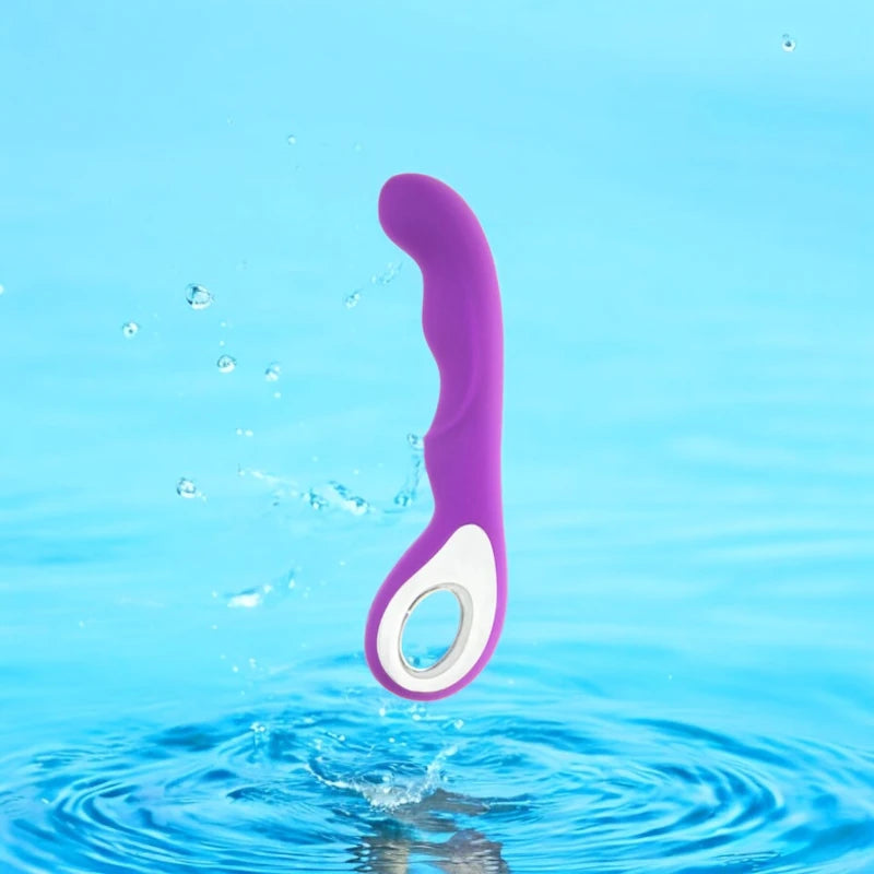 A purple vibrator with a curved  ergonomic loop handle.